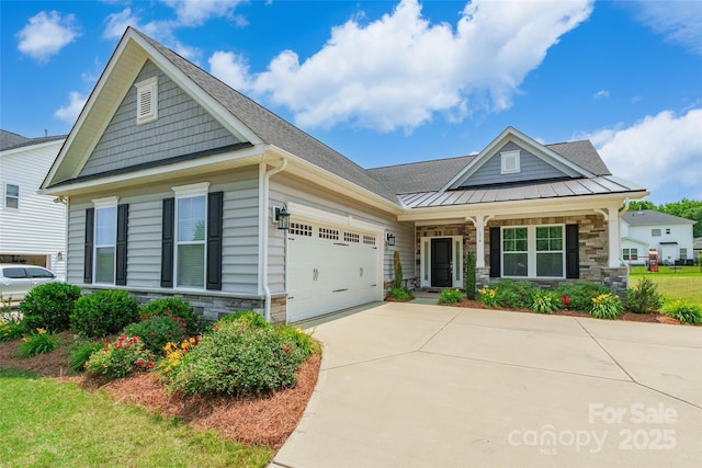 174 Pine Eagle Dr, Rock Hill, SC 29732 - craftsman inspired home featuring stone siding, an attached garage, concrete driveway, covered porch, and a standing seam roof