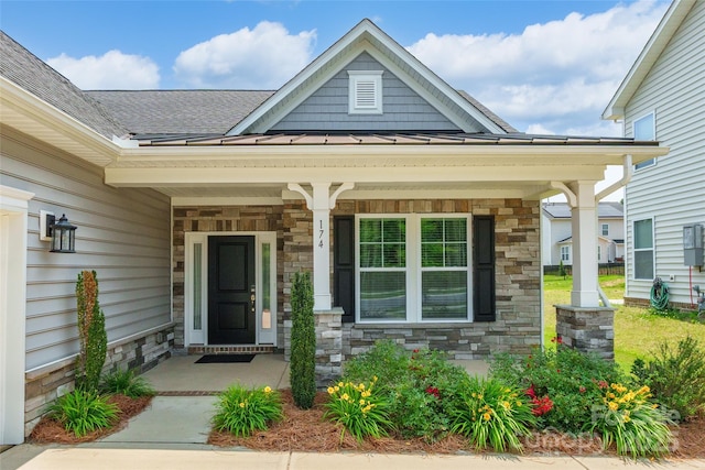 174 Pine Eagle Dr, Rock Hill, SC 29732 - entrance to property with a porch, stone siding, a standing seam roof, metal roof, and a shingled roof