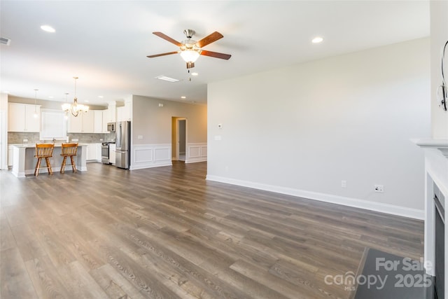 174 Pine Eagle Dr, Rock Hill, SC 29732 - unfurnished living room featuring a chandelier, a ceiling fan, recessed lighting, and dark wood finished floors
