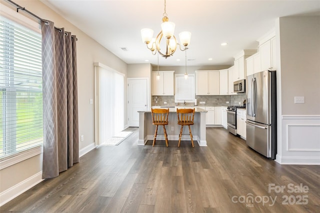 174 Pine Eagle Dr, Rock Hill, SC 29732 - kitchen with appliances with stainless steel finishes, a chandelier, light countertops, tasteful backsplash, and dark wood-type flooring