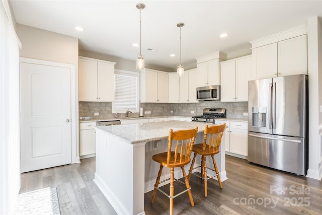 174 Pine Eagle Dr, Rock Hill, SC 29732 - kitchen with appliances with stainless steel finishes, a center island, wood finished floors, white cabinets, and recessed lighting