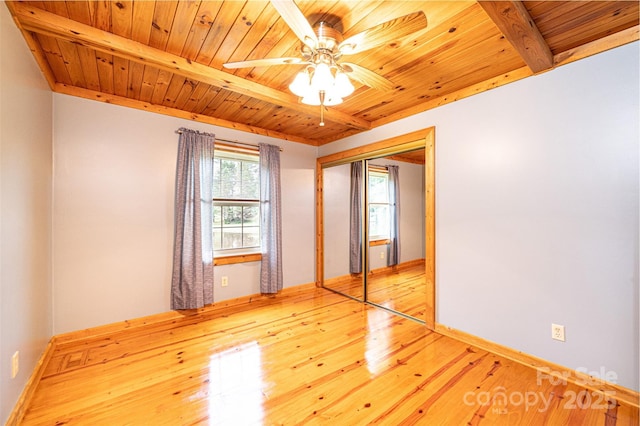 377 Birch Circle Dr, Hudson, NC 28638 - unfurnished bedroom featuring wooden ceiling with exposed beams, light wood finished floors, a closet, baseboards, and a ceiling fan