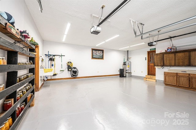 377 Birch Circle Dr, Hudson, NC 28638 - garage featuring a garage door opener, gas water heater, and baseboards