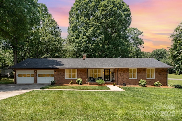 400 S Westover Dr, Monroe, NC 28112 - single story home with covered porch, an attached garage, concrete driveway, brick siding, and a front lawn