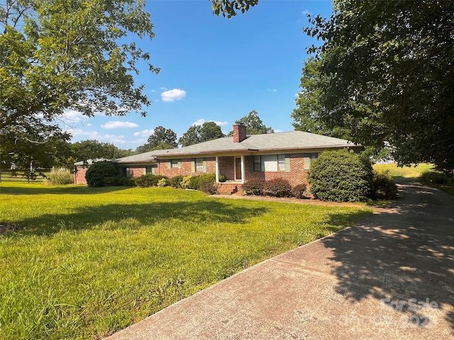 1243 Cox Mill Rd, Concord, NC 28027 - ranch-style home featuring a chimney, a front lawn, and brick siding