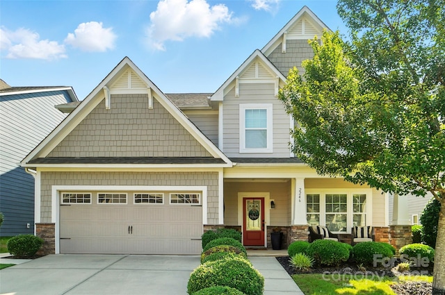 2246 Bluebell Way, Tega Cay, SC 29708 - craftsman house featuring stone siding, covered porch, concrete driveway, and an attached garage