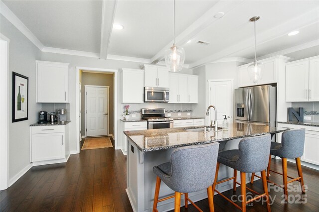 2246 Bluebell Way, Tega Cay, SC 29708 - kitchen with appliances with stainless steel finishes, a sink, beam ceiling, a breakfast bar, and dark stone counters