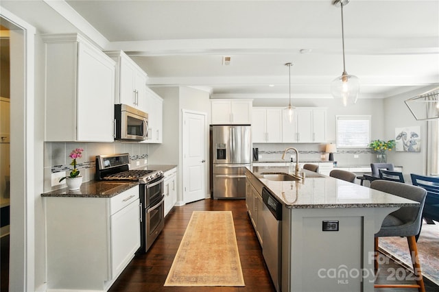 2246 Bluebell Way, Tega Cay, SC 29708 - kitchen with appliances with stainless steel finishes, a sink, a kitchen breakfast bar, dark wood-style flooring, and backsplash