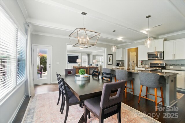 2246 Bluebell Way, Tega Cay, SC 29708 - dining area with dark wood-style flooring, a chandelier, and crown molding
