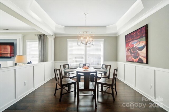 2246 Bluebell Way, Tega Cay, SC 29708 - dining area with a chandelier, a raised ceiling, dark wood-type flooring, wainscoting, and a decorative wall