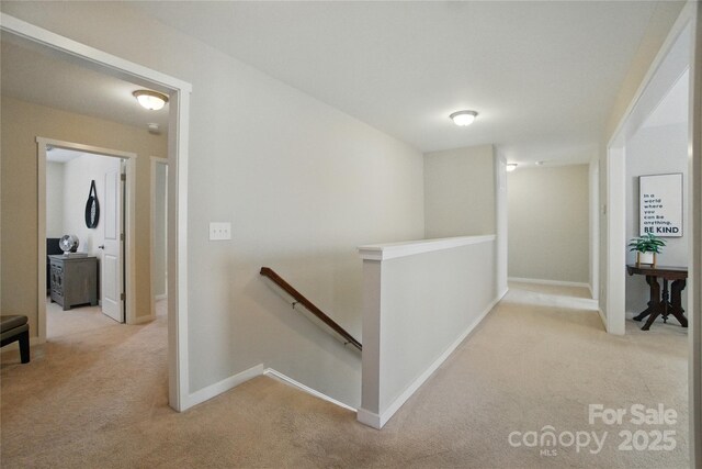 2246 Bluebell Way, Tega Cay, SC 29708 - hall with an upstairs landing, carpet flooring, and baseboards