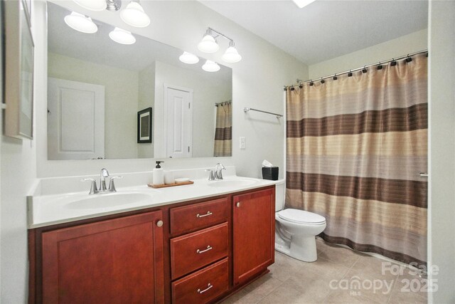 2246 Bluebell Way, Tega Cay, SC 29708 - bathroom featuring double vanity, toilet, tile patterned floors, and curtained shower