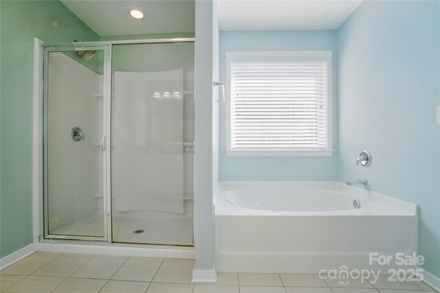 2246 Bluebell Way, Tega Cay, SC 29708 - bathroom with a shower stall, a garden tub, baseboards, and tile patterned floors