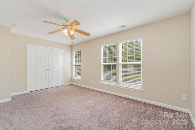 5322 Jocelyn Ln, Charlotte, NC 28269 - unfurnished bedroom with carpet flooring, baseboards, a closet, and ceiling fan