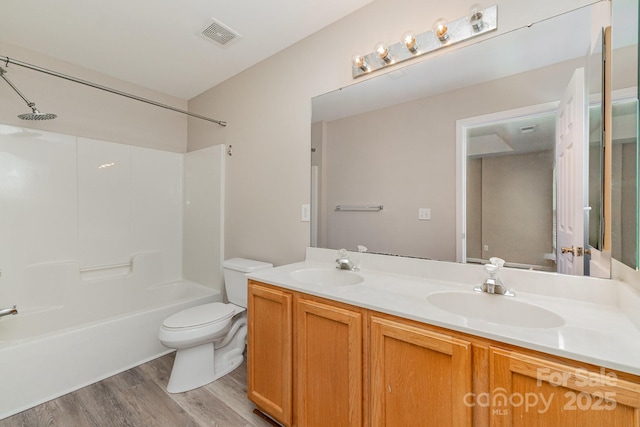 5322 Jocelyn Ln, Charlotte, NC 28269 - full bath featuring wood finished floors, toilet, double vanity, and bathing tub / shower combination