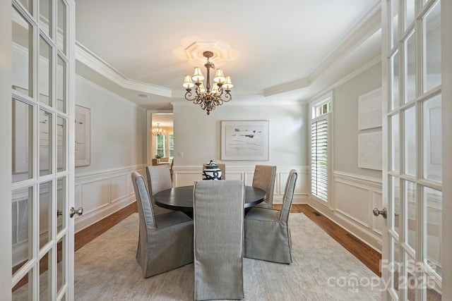 7319 Stonehaven Dr, Waxhaw, NC 28173 - dining room featuring french doors, a chandelier, wood finished floors, crown molding, and a decorative wall