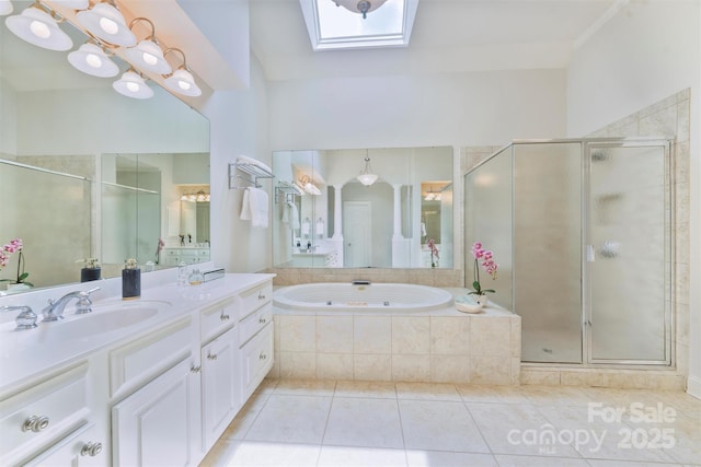 7319 Stonehaven Dr, Waxhaw, NC 28173 - full bath with a skylight, vanity, tile patterned floors, a stall shower, and a garden tub