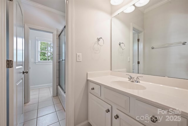 7319 Stonehaven Dr, Waxhaw, NC 28173 - bathroom featuring ornamental molding, vanity, baseboards, tile patterned floors, and enclosed tub / shower combo