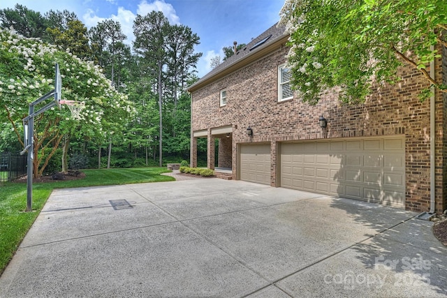 7319 Stonehaven Dr, Waxhaw, NC 28173 - view of property exterior with driveway, an attached garage, brick siding, and a lawn