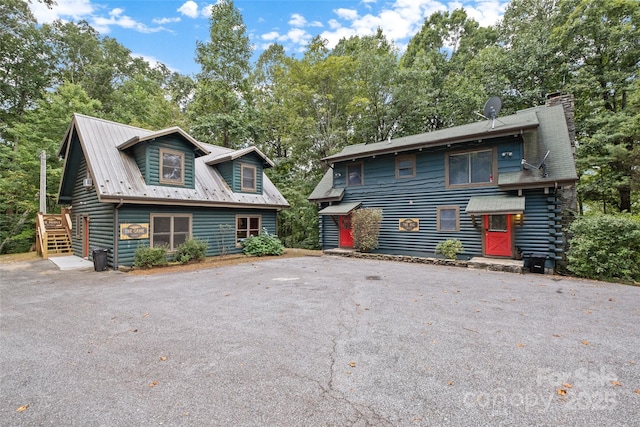 214 Mckenzie Way, Old Fort, NC 28762 - view of front of home featuring a chimney, view of scattered trees, and driveway