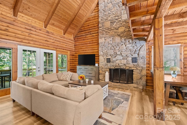 214 Mckenzie Way, Old Fort, NC 28762 - living room featuring wooden ceiling with exposed beams, wood finished floors, french doors, rustic walls, and a stone fireplace