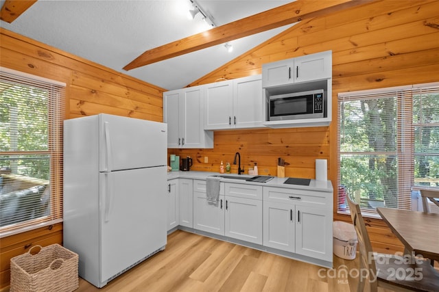 214 Mckenzie Way, Old Fort, NC 28762 - kitchen featuring freestanding refrigerator, stainless steel microwave, wood walls, light wood-style floors, and a sink