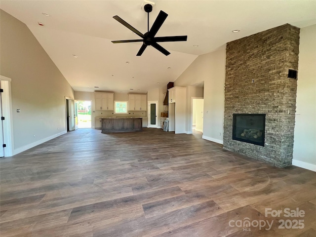 3000 Paul Payne Store Rd, Taylorsville, NC 28681 - unfurnished living room with high vaulted ceiling, a ceiling fan, a stone fireplace, and dark wood-type flooring