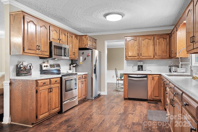 4026 Biggerstaff Rd, Maiden, NC 28650 - kitchen with appliances with stainless steel finishes, decorative backsplash, brown cabinetry, a textured ceiling, and dark wood-style flooring
