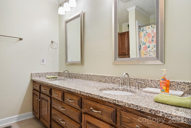 4026 Biggerstaff Rd, Maiden, NC 28650 - bathroom featuring ornamental molding, double vanity, tile patterned flooring, and a textured ceiling
