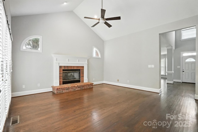 104 Fairwind Ct, Fort Mill, SC 29708 - unfurnished living room featuring high vaulted ceiling, a brick fireplace, ceiling fan, healthy amount of natural light, and wood finished floors