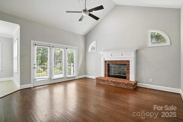 104 Fairwind Ct, Fort Mill, SC 29708 - unfurnished living room with a ceiling fan, high vaulted ceiling, a brick fireplace, and wood finished floors