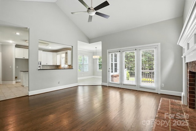 104 Fairwind Ct, Fort Mill, SC 29708 - unfurnished living room featuring wood finished floors, a fireplace, ceiling fan, high vaulted ceiling, and recessed lighting
