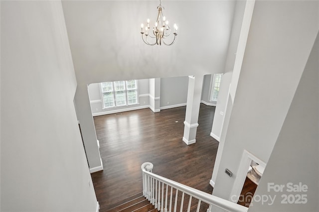 104 Fairwind Ct, Fort Mill, SC 29708 - stairway featuring a high ceiling, wood finished floors, and a chandelier