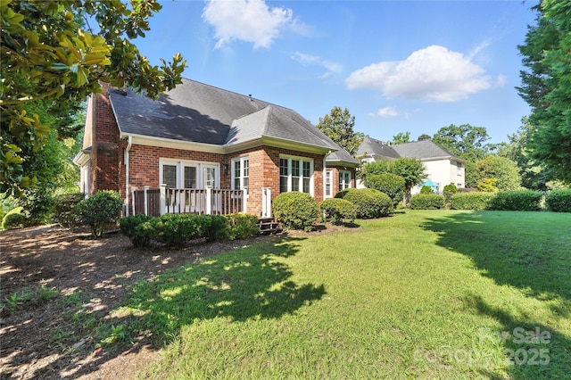 104 Fairwind Ct, Fort Mill, SC 29708 - rear view of property featuring brick siding, a yard, a wooden deck, and roof with shingles