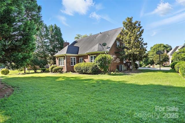 104 Fairwind Ct, Fort Mill, SC 29708 - rear view of house featuring brick siding, a yard, and a chimney