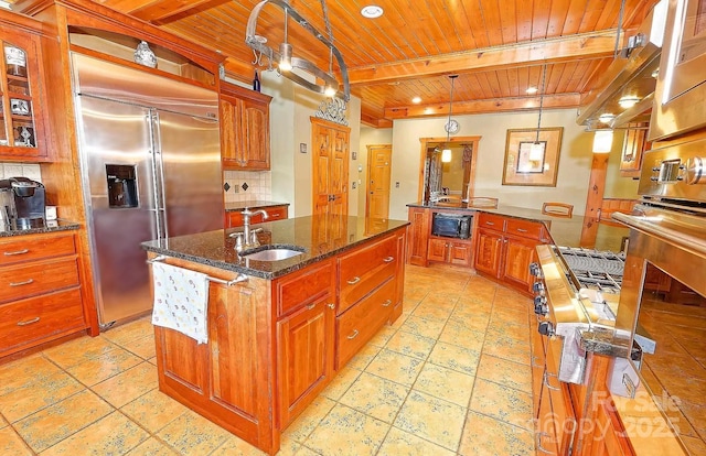 1250 Mountain Creek Rd, Rutherfordton, NC 28139 - kitchen featuring wooden ceiling with exposed beams, a sink, built in refrigerator, black microwave, and a center island with sink