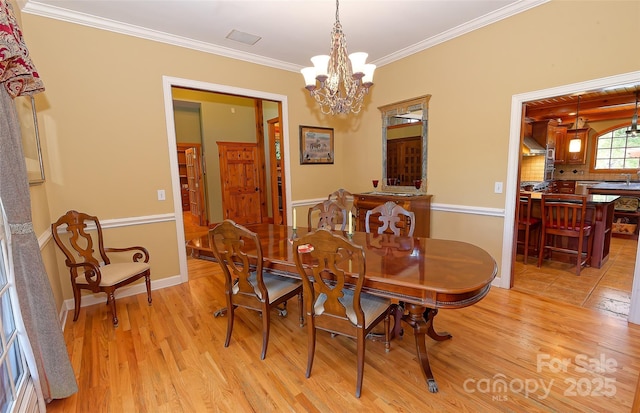1250 Mountain Creek Rd, Rutherfordton, NC 28139 - dining area featuring light wood-style flooring, ornamental molding, a chandelier, and baseboards
