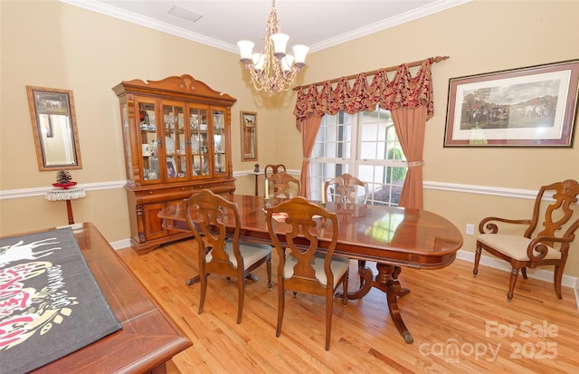 1250 Mountain Creek Rd, Rutherfordton, NC 28139 - dining space with a chandelier, light wood finished floors, ornamental molding, and baseboards