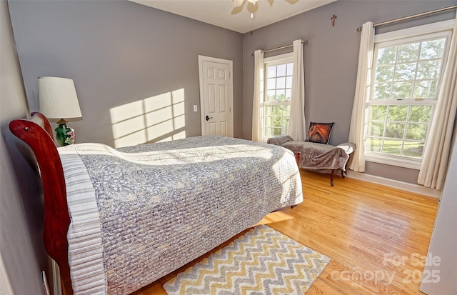 1250 Mountain Creek Rd, Rutherfordton, NC 28139 - bedroom featuring multiple windows, wood finished floors, and baseboards