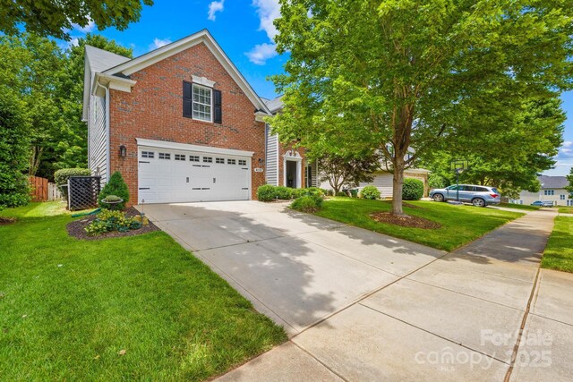 622 Lorain Ave NW, Concord, NC 28027 - view of front facade with brick siding, concrete driveway, and a garage