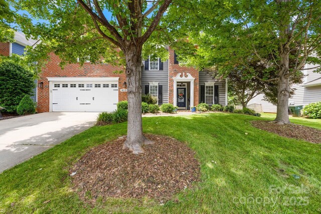 622 Lorain Ave NW, Concord, NC 28027 - view of front facade featuring brick siding, driveway, and a front yard