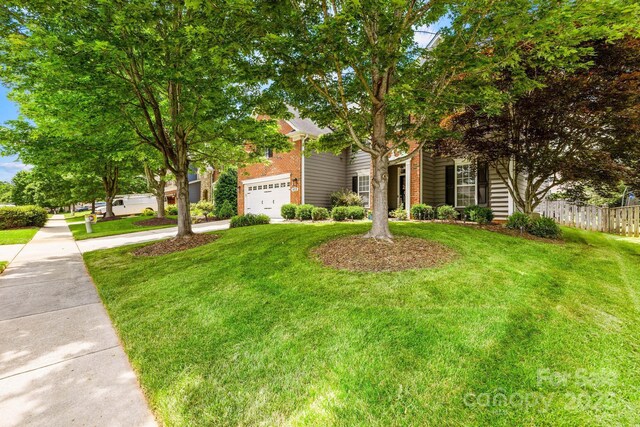 622 Lorain Ave NW, Concord, NC 28027 - obstructed view of property featuring driveway and brick siding