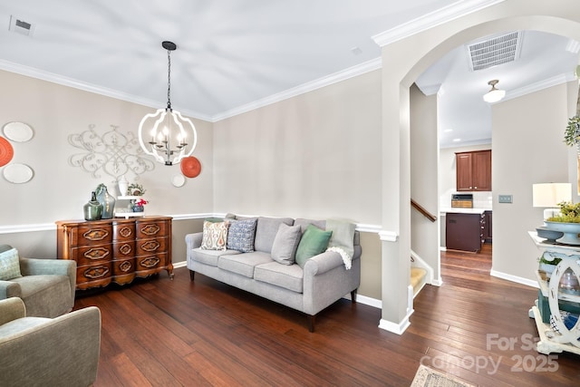 622 Lorain Ave NW, Concord, NC 28027 - living room with arched walkways, hardwood / wood-style floors, crown molding, a chandelier, and stairway