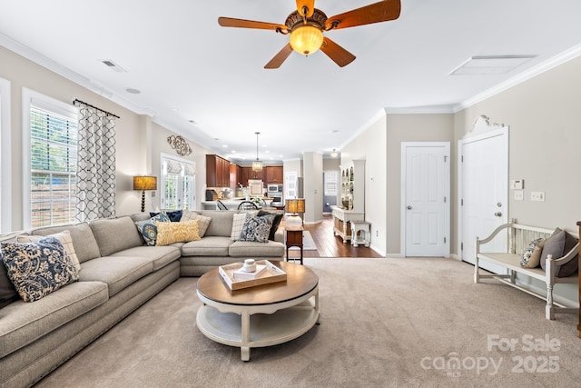 622 Lorain Ave NW, Concord, NC 28027 - carpeted living area featuring ornamental molding and ceiling fan