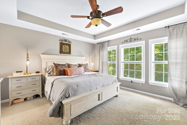622 Lorain Ave NW, Concord, NC 28027 - bedroom featuring light colored carpet, a raised ceiling, and a ceiling fan