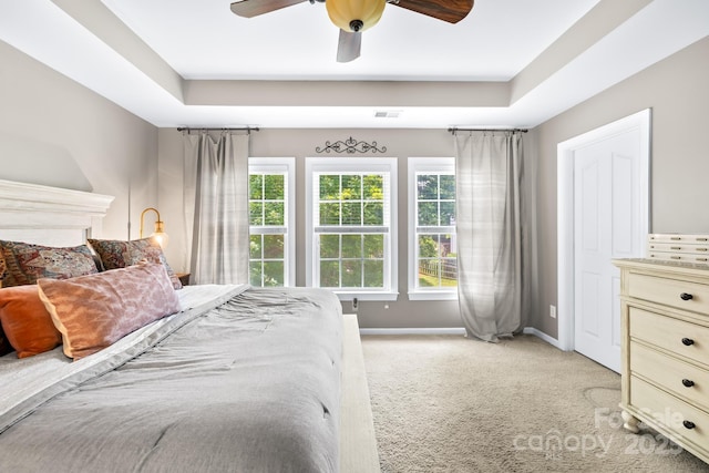 622 Lorain Ave NW, Concord, NC 28027 - bedroom featuring light carpet, a raised ceiling, and a ceiling fan