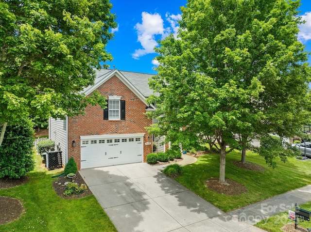 622 Lorain Ave NW, Concord, NC 28027 - view of front of house with a garage, brick siding, driveway, and a front lawn