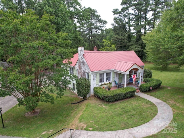 1614 Linwood Rd, Gaston, NC 28052 - view of front of house with a chimney, a front lawn, and metal roof