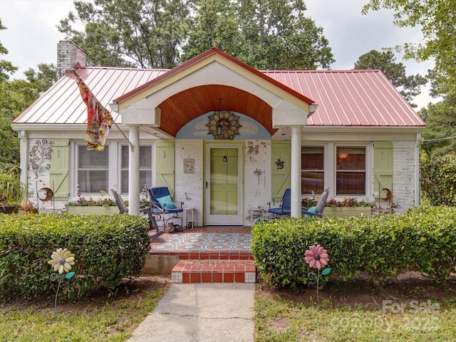 1614 Linwood Rd, Gaston, NC 28052 - view of front of house featuring metal roof, a chimney, brick siding, a porch, and a standing seam roof