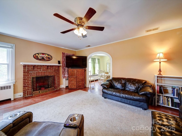 1614 Linwood Rd, Gaston, NC 28052 - living room with radiator, a ceiling fan, plenty of natural light, arched walkways, and crown molding